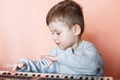 Little Cut Boy playing the digital piano. Happy childhood and music. Royalty Free Stock Photo