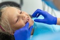Little cute adorable happy caucasian blond kid girl at dentist office at dentist check-up of dental braces. Child during