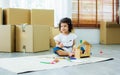 Little cute adorable sweet Caucasian curly hair girl smiling, raising hand with fun, playing and using color pencils drawing on Royalty Free Stock Photo