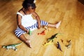 Little cute african american girl playing with animal toys at ho Royalty Free Stock Photo