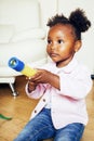 Little cute african american girl playing with animal toys at home, pretty adorable princess in interior happy smiling Royalty Free Stock Photo