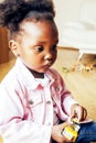 little cute african american girl playing with animal toys at home, pretty adorable princess in interior happy smiling Royalty Free Stock Photo