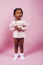 Little cute african girl posing cheerful inocent on pink background, lifestyle people concept Royalty Free Stock Photo