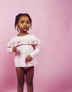 Little cute african girl posing cheerful inocent on pink background, lifestyle people concept Royalty Free Stock Photo