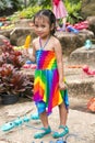 Little cute asian girl in a bright dress with ice cream