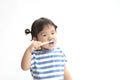 A little cute asian girl brushing her teeth isolated on white background Royalty Free Stock Photo