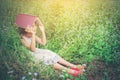 Little cute asian girl cover book on her head at nature. Royalty Free Stock Photo