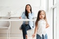 Little cute asian girl playing while her mother is working Royalty Free Stock Photo