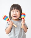 Little cute asian girl playing the maracas Royalty Free Stock Photo