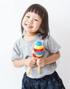 Little cute asian girl playing the maracas