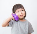 Little cute asian girl talking with the plastic phone. Royalty Free Stock Photo