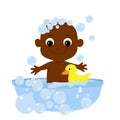 Little cute baby bathes in a bathtub with soap bubbles and a yellow rubber duck. The child is African or African American and