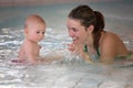 Little cute baby boy, swimming happily in a shallow pool water Royalty Free Stock Photo