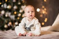 Little cute baby boy in winter body posing in the studio with decor. Copy space. Royalty Free Stock Photo