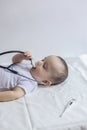 Little cute baby doctor. 6-month old baby boy playing with stethoscope. Kid having fun like a doctor Royalty Free Stock Photo