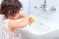 Little cute baby girl cleaning her teeth with toothbrush in the bathroom. Royalty Free Stock Photo