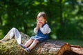 Little cute baby girl eating fruit in forest Royalty Free Stock Photo