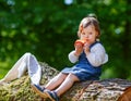 Little cute baby girl eating fruit in forest Royalty Free Stock Photo