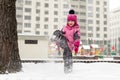 Little cute baby girl having fun on playground at winter. Children winter sport and leisure outdoor activities Royalty Free Stock Photo