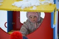 Little cute baby girl having fun on playground at winter. Children winter sport and leisure outdoor activities Royalty Free Stock Photo