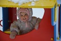 Little cute baby girl having fun on playground at winter. Children winter sport and leisure outdoor activities Royalty Free Stock Photo