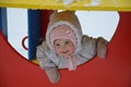 Little cute baby girl having fun on playground at winter. Children winter sport and leisure outdoor activities Royalty Free Stock Photo