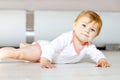 Little cute baby girl learning to crawl. Healthy child crawling in kids room. Smiling happy healthy toddler girl. Cute Royalty Free Stock Photo