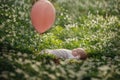 Little cute baby girl lying on the grass in the park in summer day. Royalty Free Stock Photo