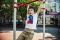 Little cute blond boy hanging on playground outside, alone training with fun, lifestyle children concept Royalty Free Stock Photo