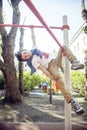 Little cute blond boy hanging on playground outside, alone training with fun, lifestyle children concept Royalty Free Stock Photo
