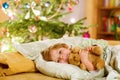 Little cute blond child sleeping under Christmas tree Royalty Free Stock Photo