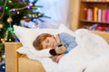 Little cute blond child sleeping under Christmas tree Royalty Free Stock Photo