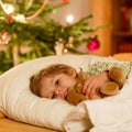 Little cute blond child sleeping under Christmas tree Royalty Free Stock Photo