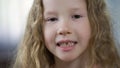 Little cute blond girl showing teeth into camera, children orthodontics, health