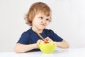 Little cute blonde boy refuses to eat porridge Royalty Free Stock Photo