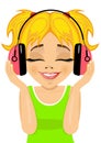 Little cute blonde girl enjoys listening to music with headphones Royalty Free Stock Photo