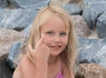 Little cute blonde shows something with her fingers Royalty Free Stock Photo