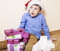 Little cute boy with Christmas gifts at home