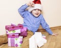Little cute boy with Christmas gifts at home