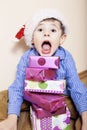 Little cute boy with Christmas gifts at home