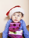 Little cute boy with Christmas gifts at home