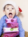 Little cute boy with Christmas gifts at home