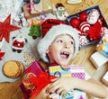 Little cute boy with Christmas gifts at home. close up emotional happy smiling in mess with toys, lifestyle holiday Royalty Free Stock Photo