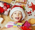 Little cute boy with Christmas gifts at home. close up emotional happy smiling in mess with toys, lifestyle holiday Royalty Free Stock Photo