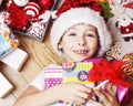 little cute boy with Christmas gifts at home. close up emotional happy smiling in mess with toys, lifestyle holiday real Royalty Free Stock Photo