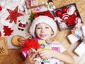 Little cute boy with Christmas gifts at home. close up emotional happy smiling in mess with toys, lifestyle holiday real Royalty Free Stock Photo