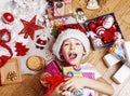 Little cute boy with Christmas gifts at home. close up emotional happy smiling in mess with toys, lifestyle holiday real Royalty Free Stock Photo