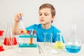 Little cute boy is engaged in chemical experiments in laboratory