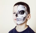 Little cute boy with facepaint like skeleton to celebrate halloween