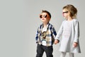 Little cute boy girl hold hands playing on grey background Royalty Free Stock Photo